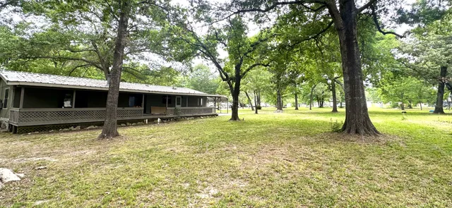 a view of a house with a backyard