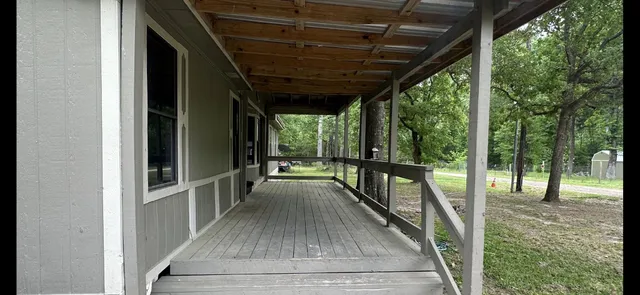 a view of porch with wooden floor
