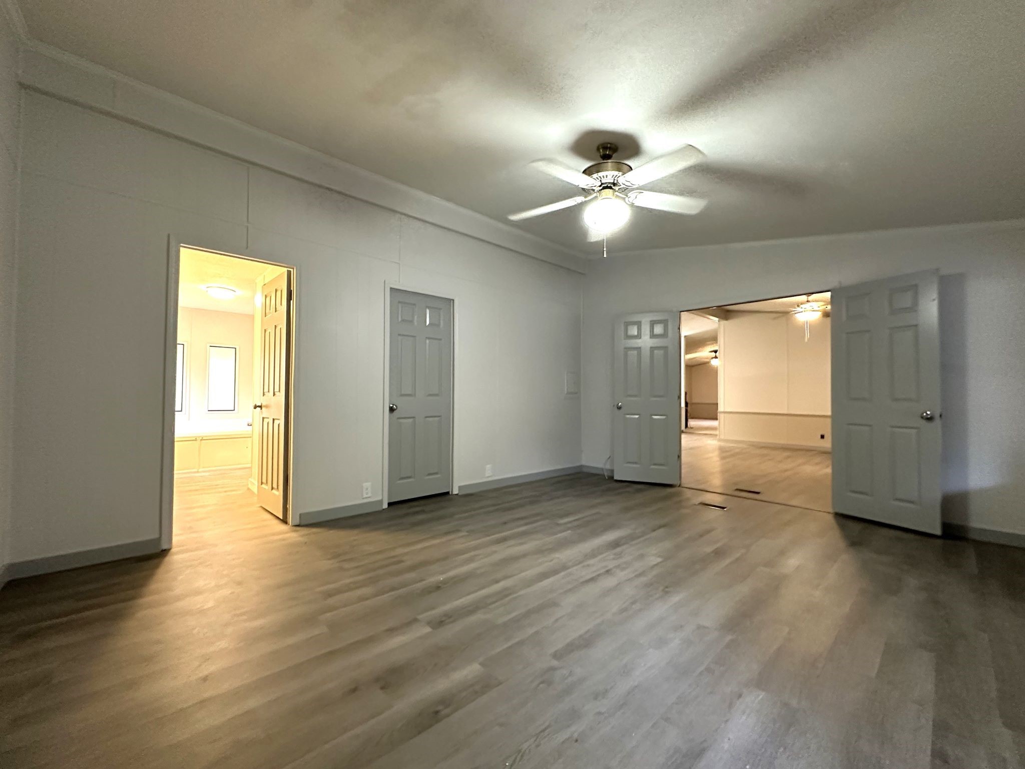 195 Charlies Lane Trinity, TX 75862 - Photo 10 of 25 a view of an empty room with wooden floor and a window