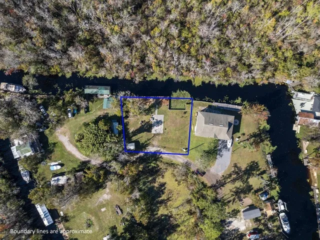 an aerial view of a house with a yard