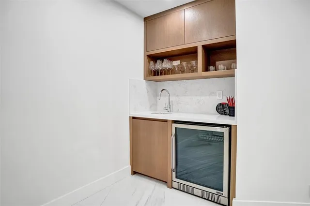 a bathroom with a sink and a potted plant