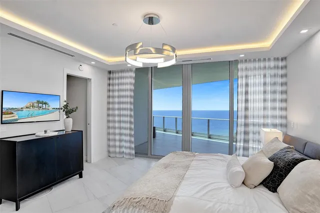 a large white kitchen with a large window
