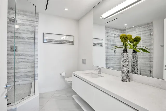 a close view of a sink a vanity and a shower curtain