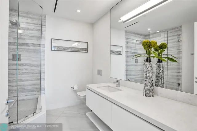 a close view of a sink a vanity and a shower curtain
