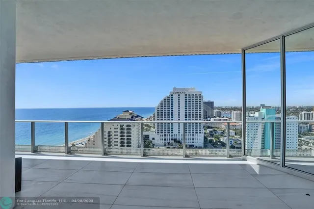 a view of a living room and kitchen with a large window