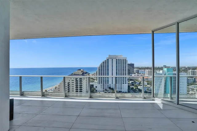 a view of a living room and kitchen with a large window