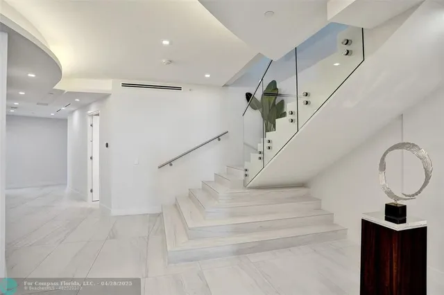 a living room with furniture a rug and a large window
