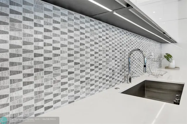 a kitchen with stainless steel appliances kitchen island granite countertop a refrigerator and a sink