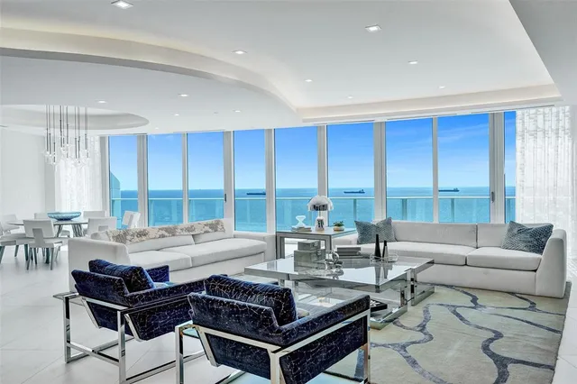 a dining room with furniture and a chandelier