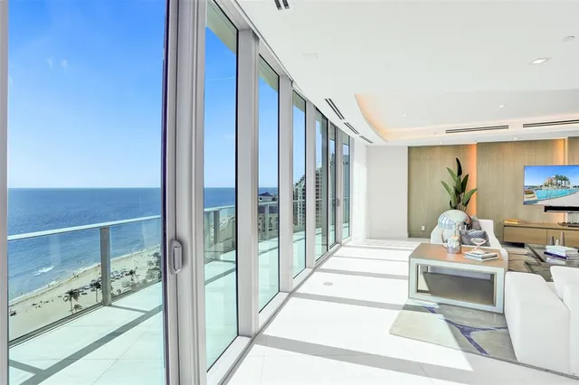 a living room with couch and a view of kitchen