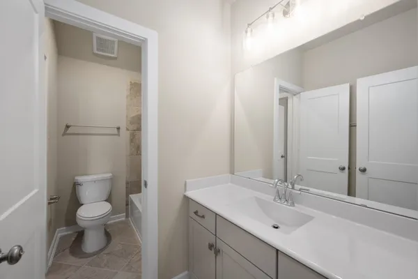 a bathroom with a shower and toilet