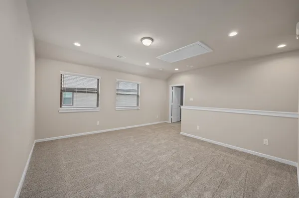 an empty room with windows and closet