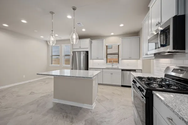 a kitchen with a sink stove and refrigerator