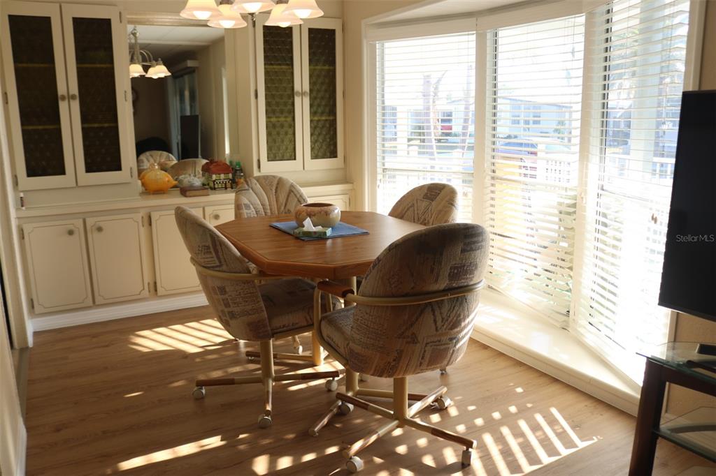 316 Estrada Street North Port, FL 34287 - Photo 11 of 59 a dining room with furniture and wooden floor