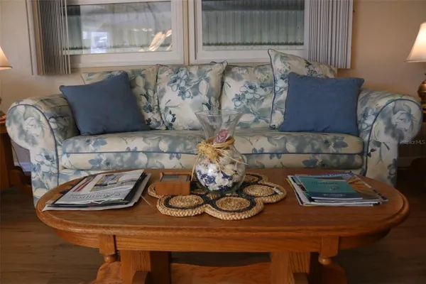 a living room with furniture and a lamp