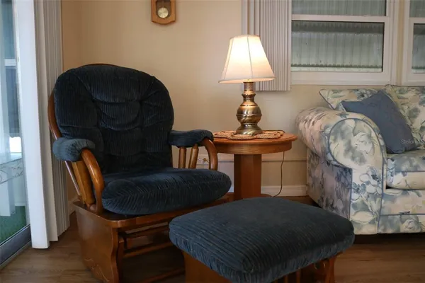 a bed sitting in a bedroom next to a lamp