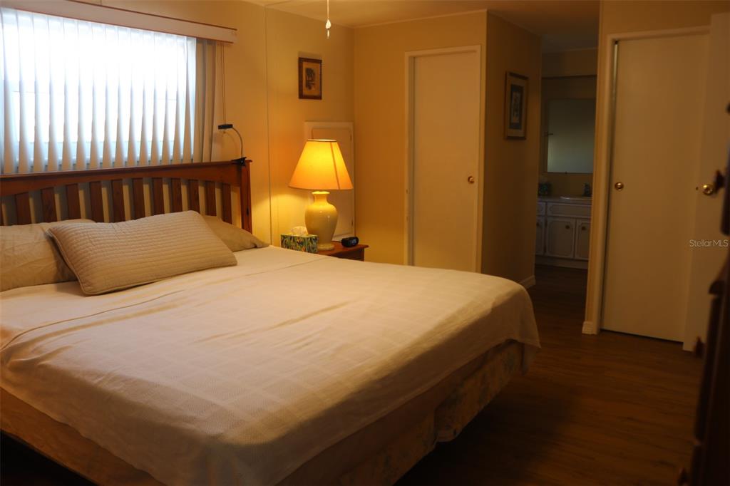 316 Estrada Street North Port, FL 34287 - Photo 21 of 59 a bedroom with a bed and wooden floor