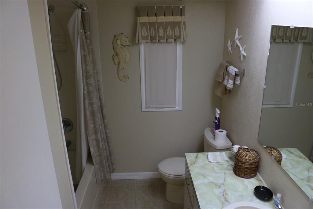 316 Estrada Street North Port, FL 34287 - Photo 23 of 59 a bathroom with a granite countertop sink toilet and vanity