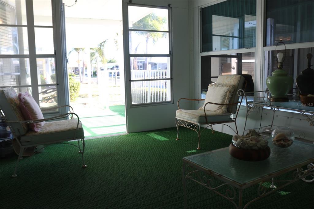 316 Estrada Street North Port, FL 34287 - Photo 34 of 59 a living room with furniture and a floor to ceiling window