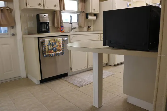 a living room with furniture and floor to ceiling windows