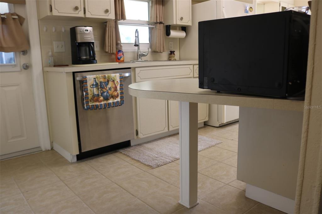 316 Estrada Street North Port, FL 34287 - Photo 8 of 59 a kitchen with stainless steel appliances a refrigerator and a stove