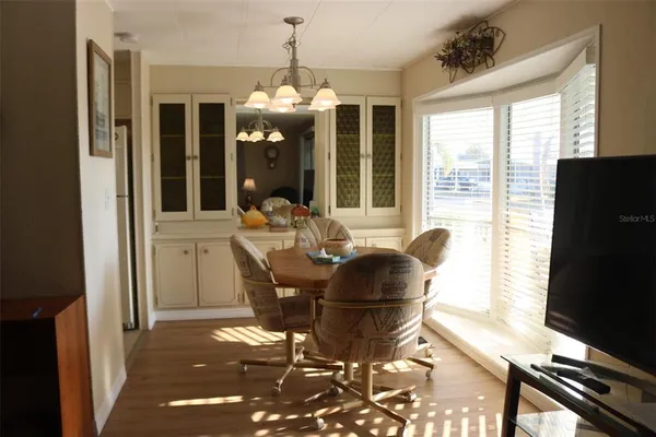 a dining room with furniture and wooden floor