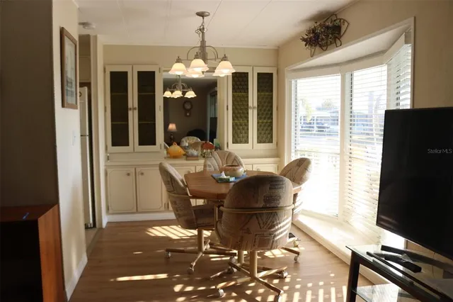 a dining room with furniture and wooden floor