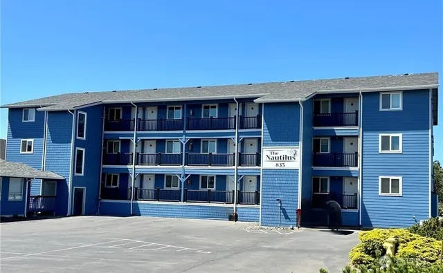 a front view of a building with a garden
