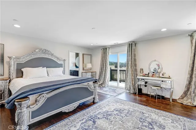 a bedroom with a bed and a bookshelf with wooden floor