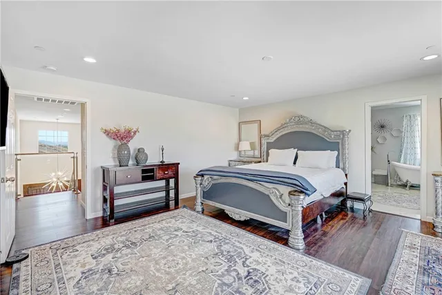 a bedroom with a bed and a dresser in it