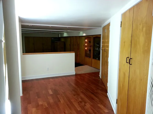 a view of hallway with wooden floor