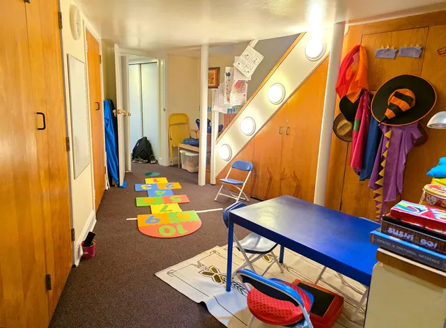a view of a room with furniture and wooden floor