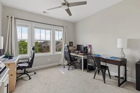 a view of a workspace with furniture and a window