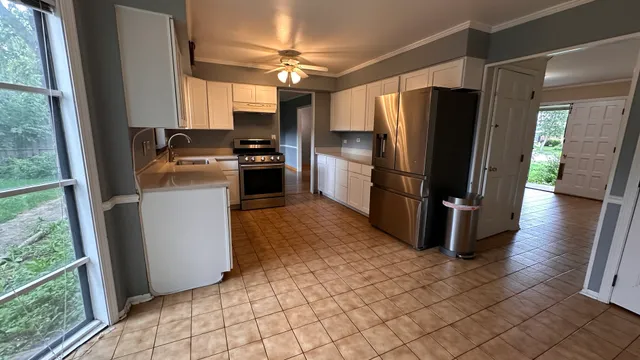 a kitchen with stainless steel appliances a refrigerator and a stove