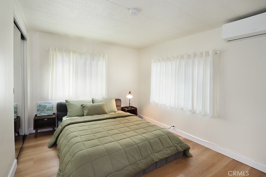 17261 Gothard Street, Unit 60 Huntington Beach, CA 92647 - Photo 12 of 27 a bedroom with a bed and a window