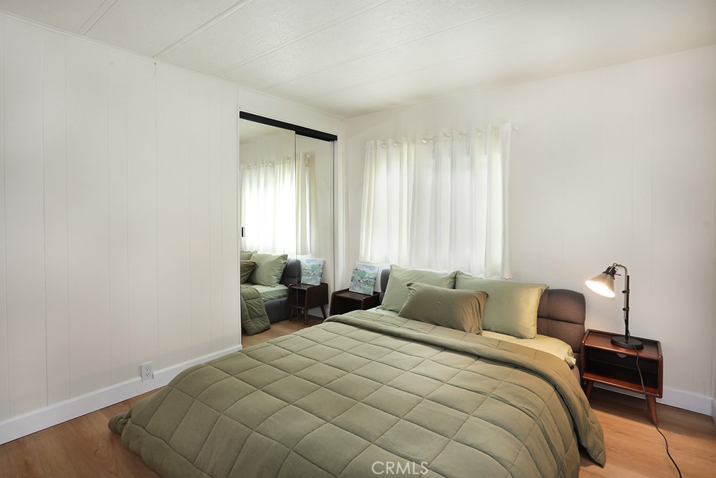 17261 Gothard Street, Unit 60 Huntington Beach, CA 92647 - Photo 13 of 27 a bedroom with a bed and a window