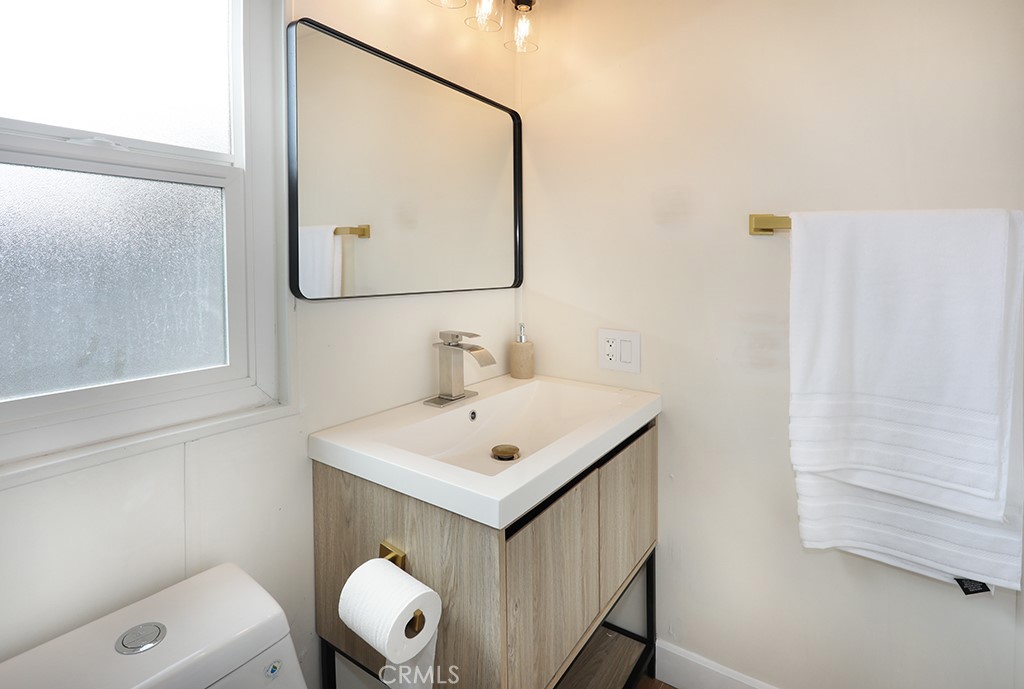 17261 Gothard Street, Unit 60 Huntington Beach, CA 92647 - Photo 14 of 27 a bathroom with a sink vanity and a mirror