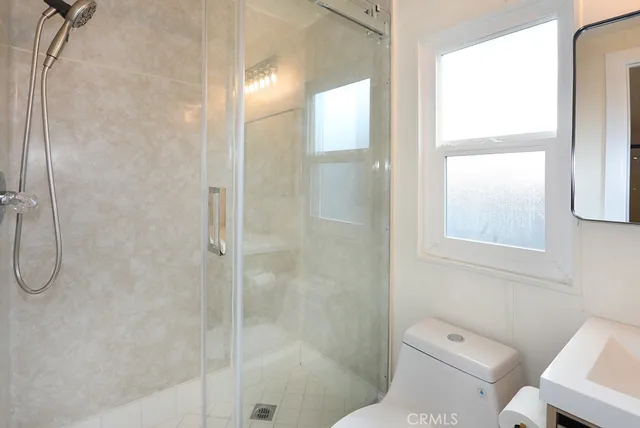 a bathroom with a shower and toilet