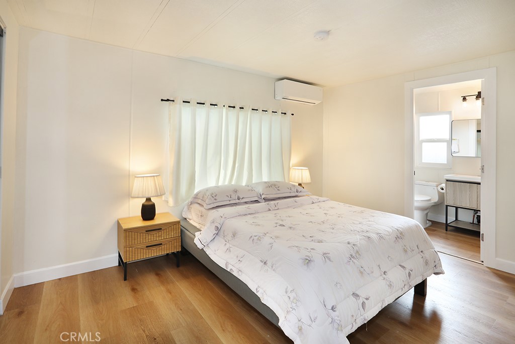 17261 Gothard Street, Unit 60 Huntington Beach, CA 92647 - Photo 16 of 27 a bedroom with a bed and a lamp