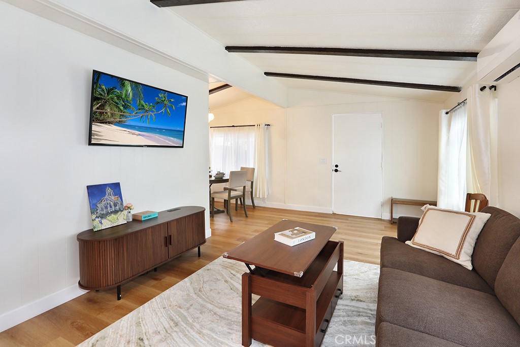 17261 Gothard Street, Unit 60 Huntington Beach, CA 92647 - Photo 19 of 27 a living room with furniture and a table