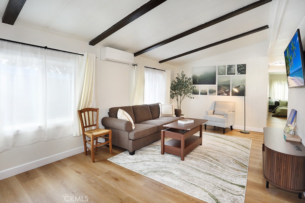 17261 Gothard Street, Unit 60 Huntington Beach, CA 92647 - Photo 20 of 27 a living room with furniture and a large window
