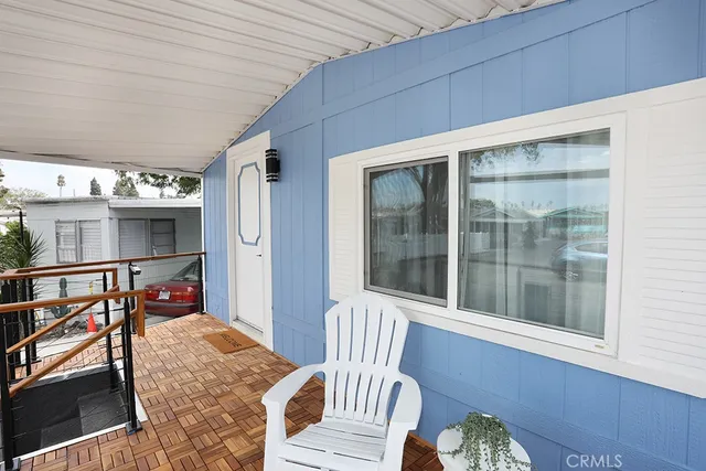 a balcony with furniture and a potted plant