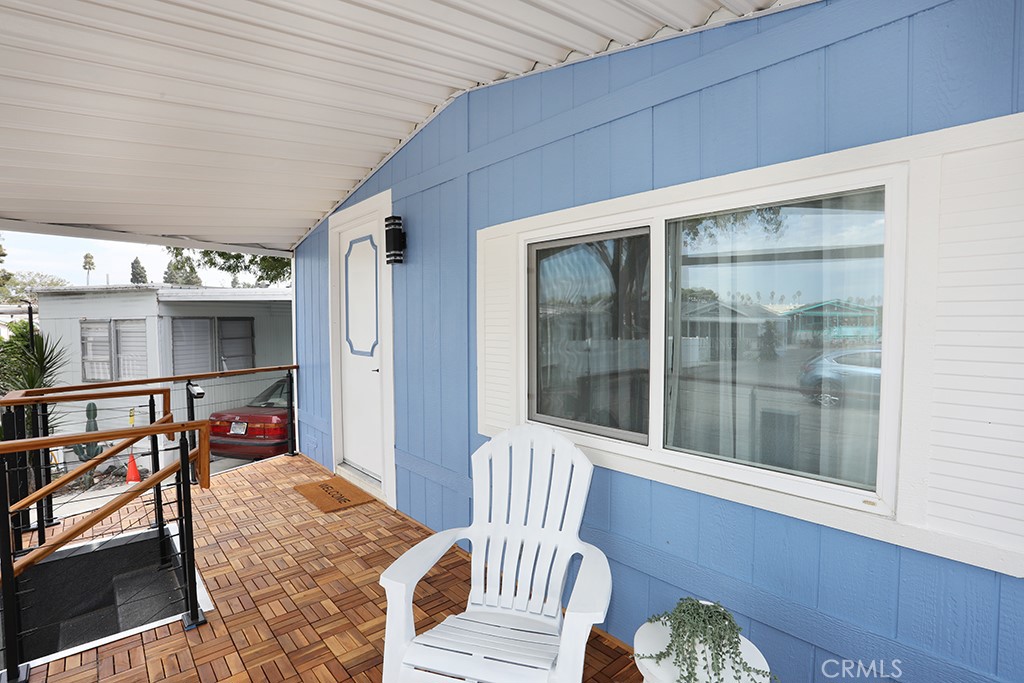 17261 Gothard Street, Unit 60 Huntington Beach, CA 92647 - Photo 2 of 27 a balcony with furniture and a potted plant