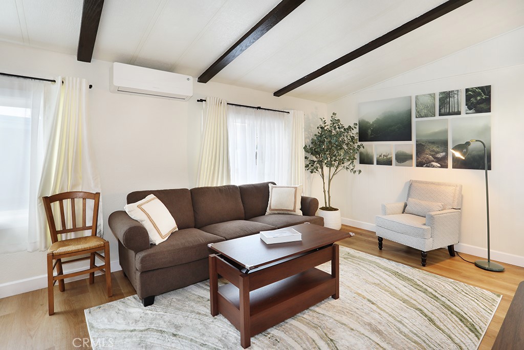 17261 Gothard Street, Unit 60 Huntington Beach, CA 92647 - Photo 21 of 27 a living room with furniture and wooden floor