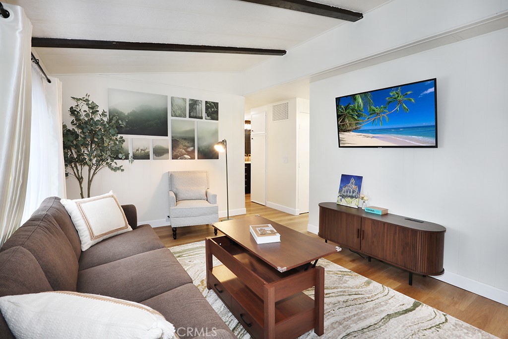 17261 Gothard Street, Unit 60 Huntington Beach, CA 92647 - Photo 3 of 27 a living room with furniture and wooden floor
