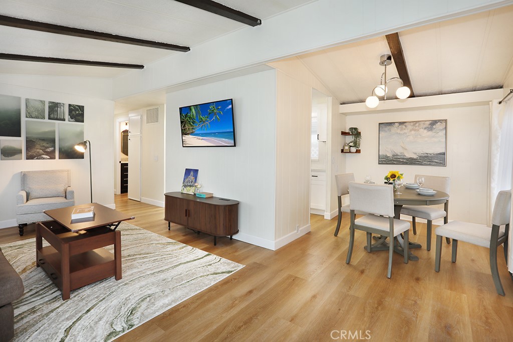 17261 Gothard Street, Unit 60 Huntington Beach, CA 92647 - Photo 4 of 27 a living room with furniture and a wooden floor