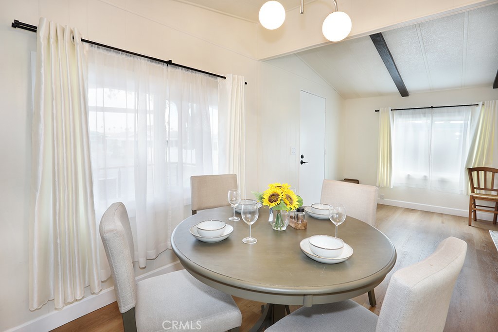 17261 Gothard Street, Unit 60 Huntington Beach, CA 92647 - Photo 6 of 27 a view of a dining room with furniture and wooden floor