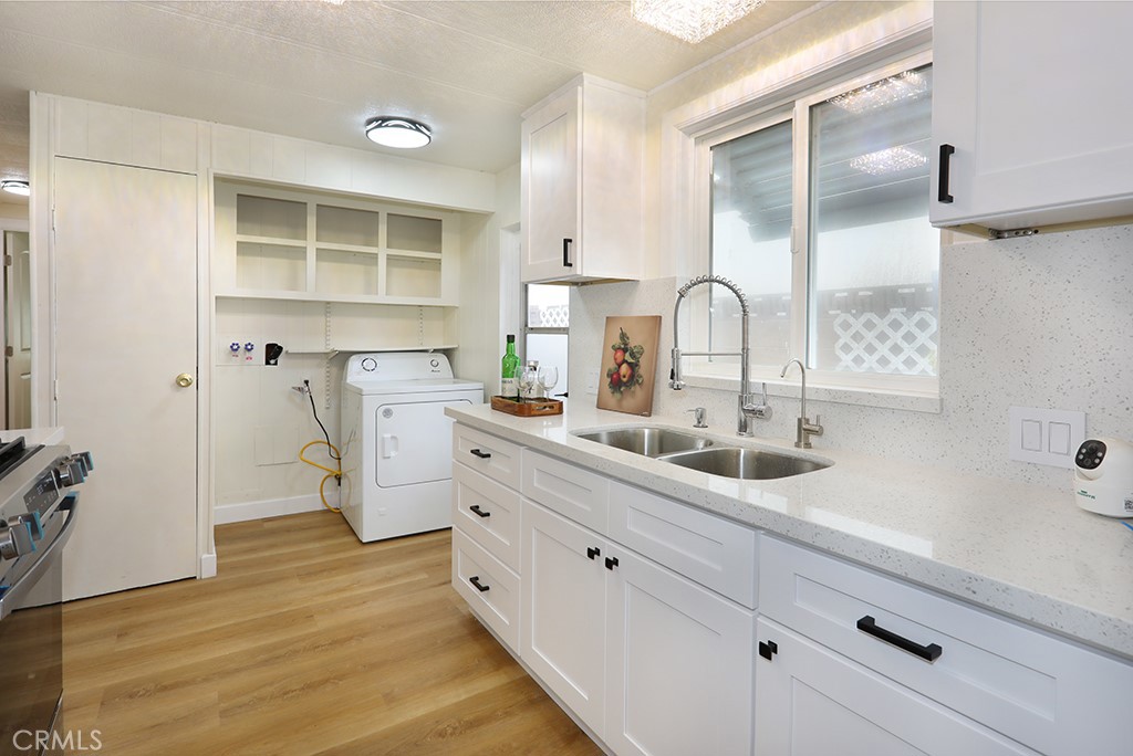 17261 Gothard Street, Unit 60 Huntington Beach, CA 92647 - Photo 8 of 27 a kitchen with appliances a sink and cabinets