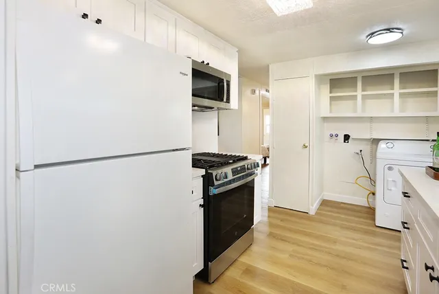 a kitchen with a refrigerator and a stove