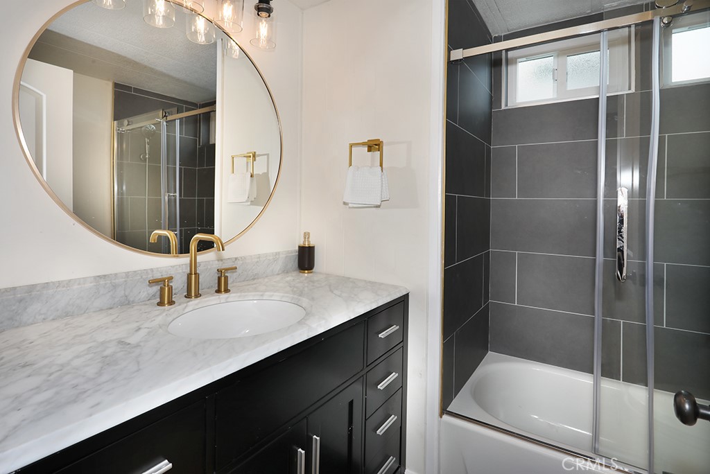 17261 Gothard Street, Unit 60 Huntington Beach, CA 92647 - Photo 10 of 27 a bathroom with a sink and a mirror